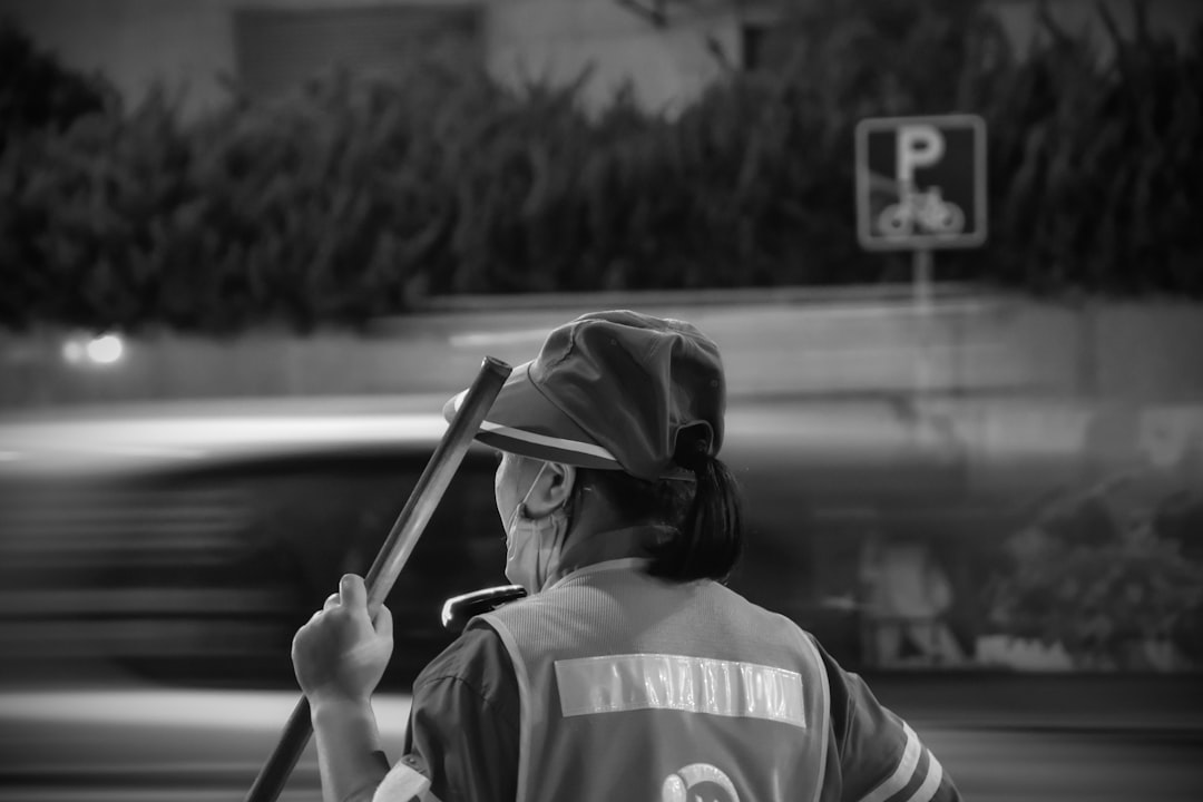 grayscale photo of man in hoodie holding a stick barcelona benfica tactics coach strategy