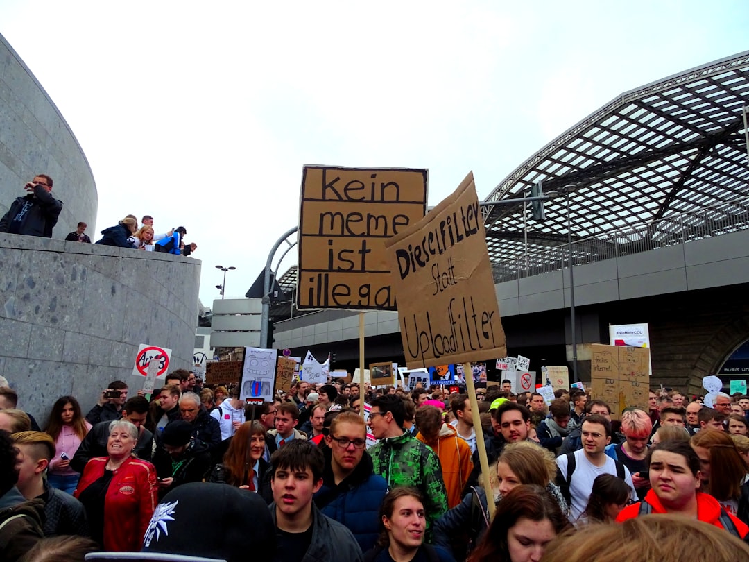 group of people gathering beside building fans holding signs, stadium engagement, crowd energy