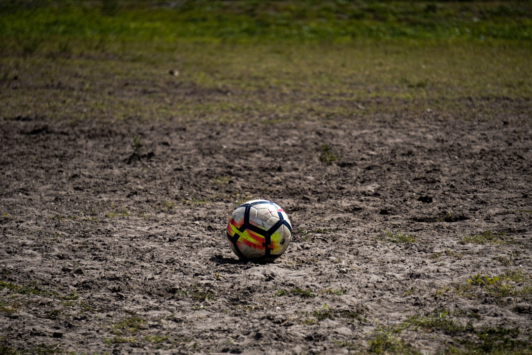 white soccer ball football injury, rainy game, unpredictable outcome