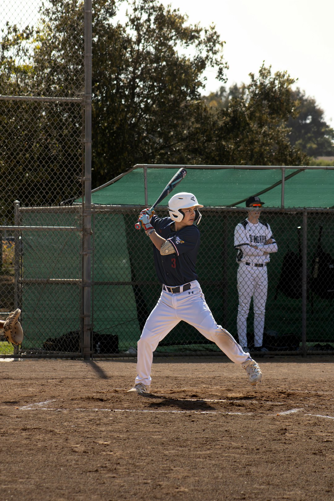 A baseball player is getting ready to swing. baseball showcase scouting athlete