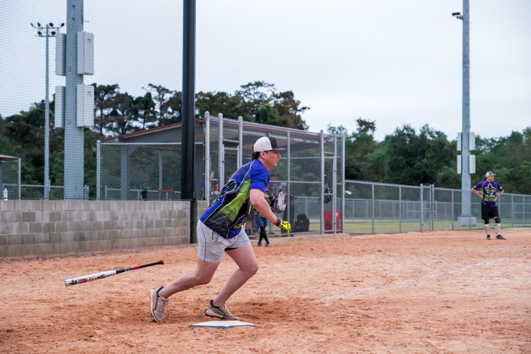 A baseball player is running to first base baseball showcase scouting athlete