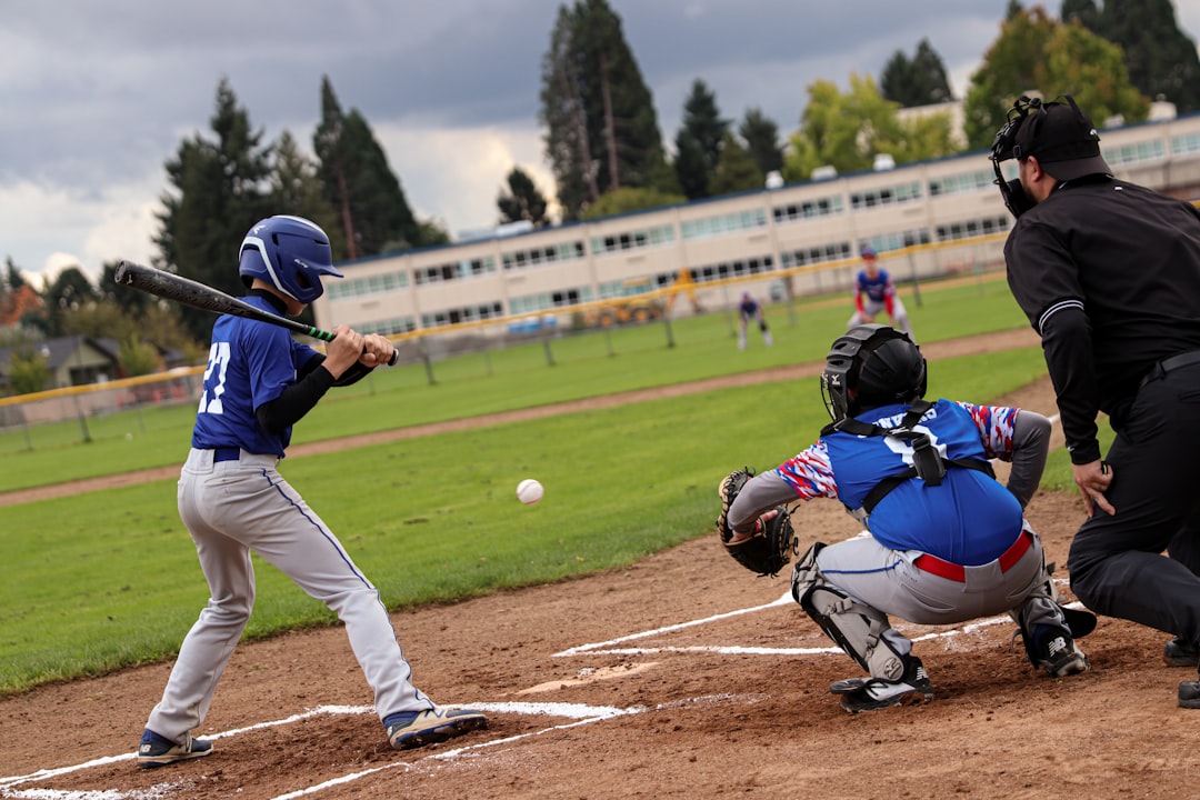 a batter, catcher and umpire during a baseball game insurance agent youth baseball forms clipboard