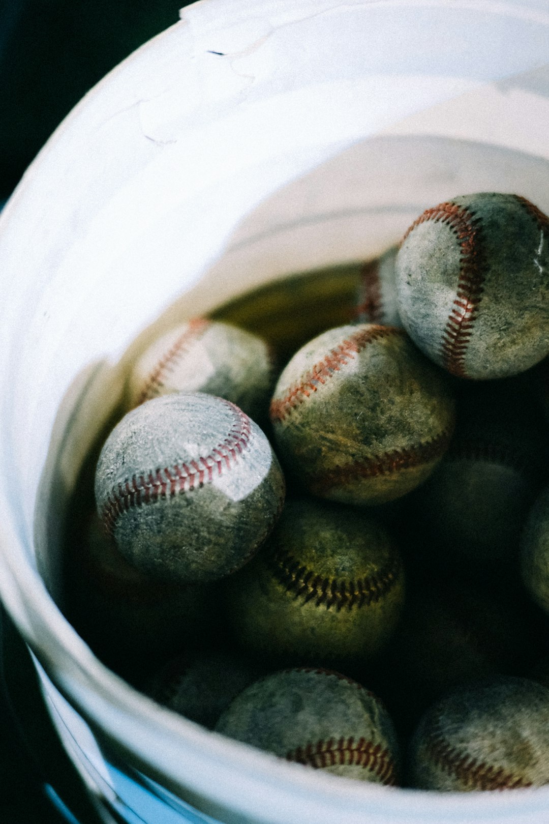 a bucket filled with baseballs sitting on top of a table celebration home run baseball betting
