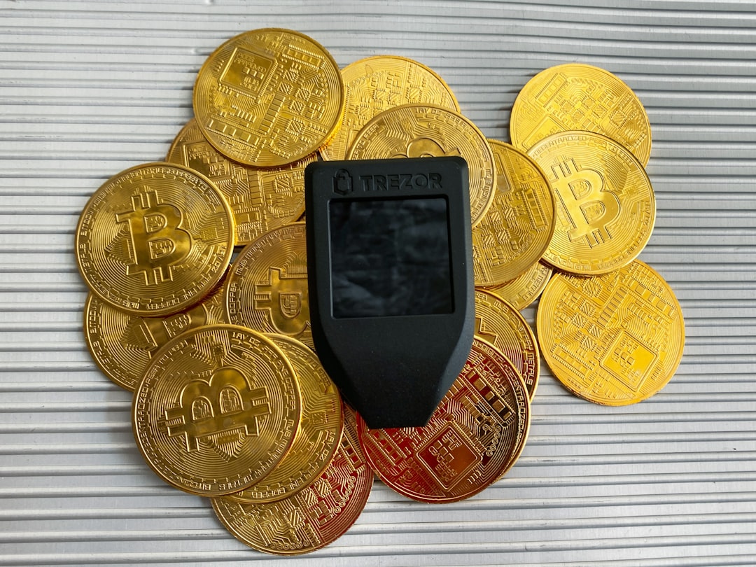 a cell phone sitting on top of a pile of gold coins bitcoin cryptocurrency mobile wallet