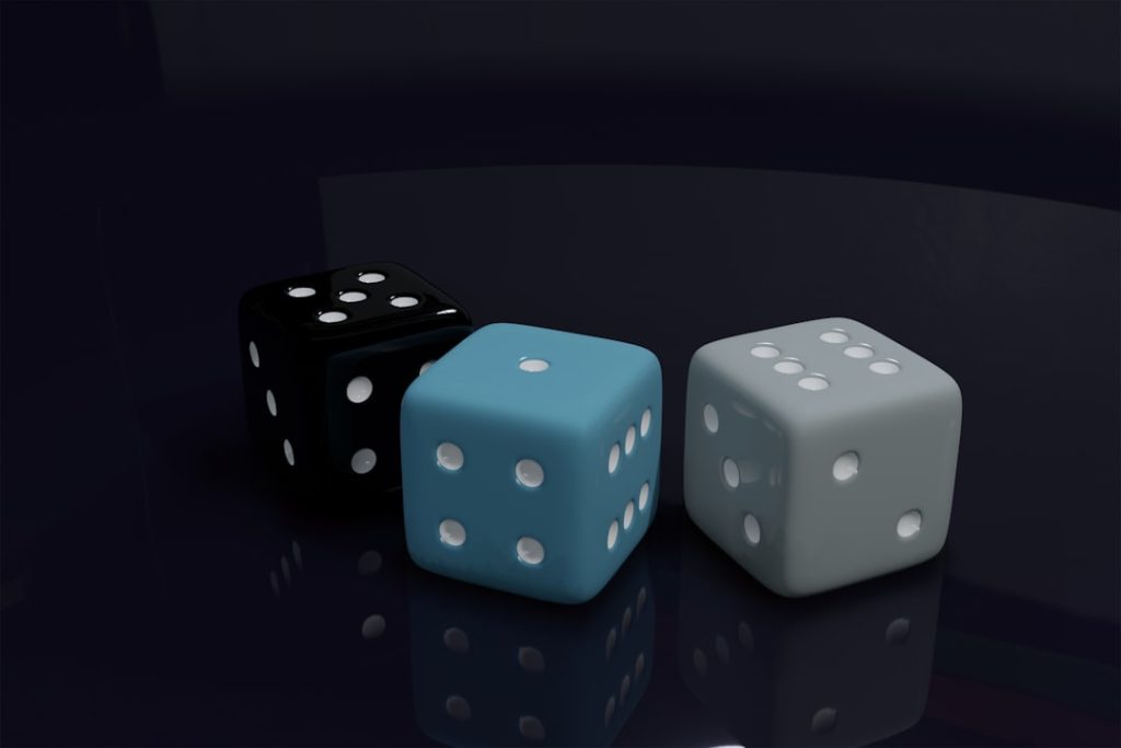 a couple of dice sitting on top of a table monte carlo simulation, betting charts, statistical modeling