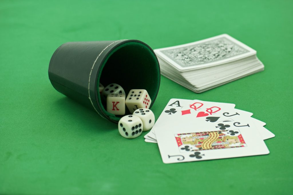 a green table with playing cards and dice sports odds board, vegas sportsbook, betting lines