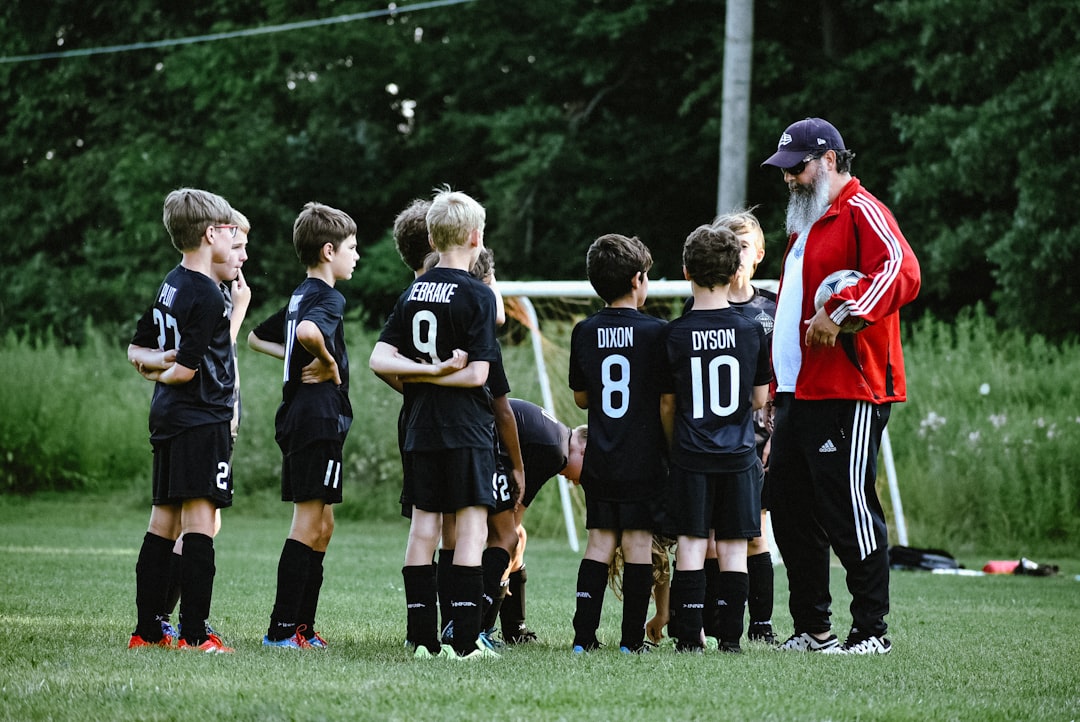 a group of boys in football uniforms team communication, sports parents, kids teams