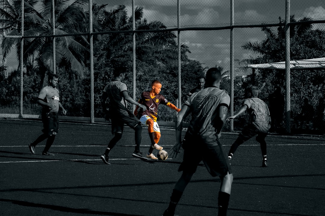 a group of men playing football teambuilding activities, high school football huddle, players bonding