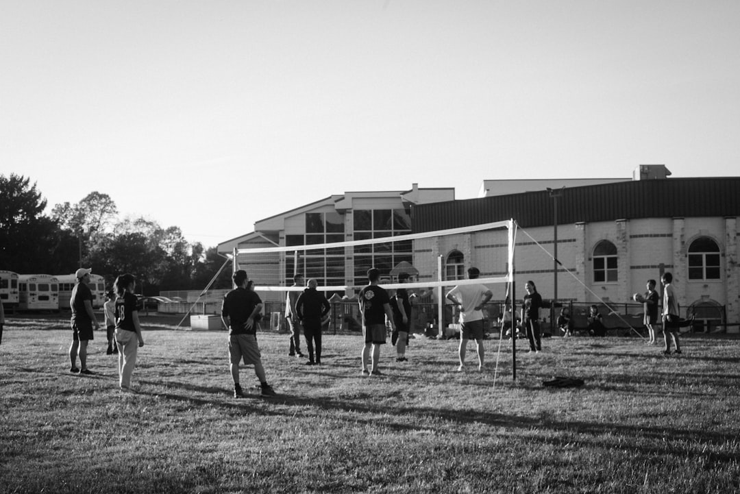 A group of people playing a game of volleyball wicksburg football training, high school athletes lifting, early morning practice