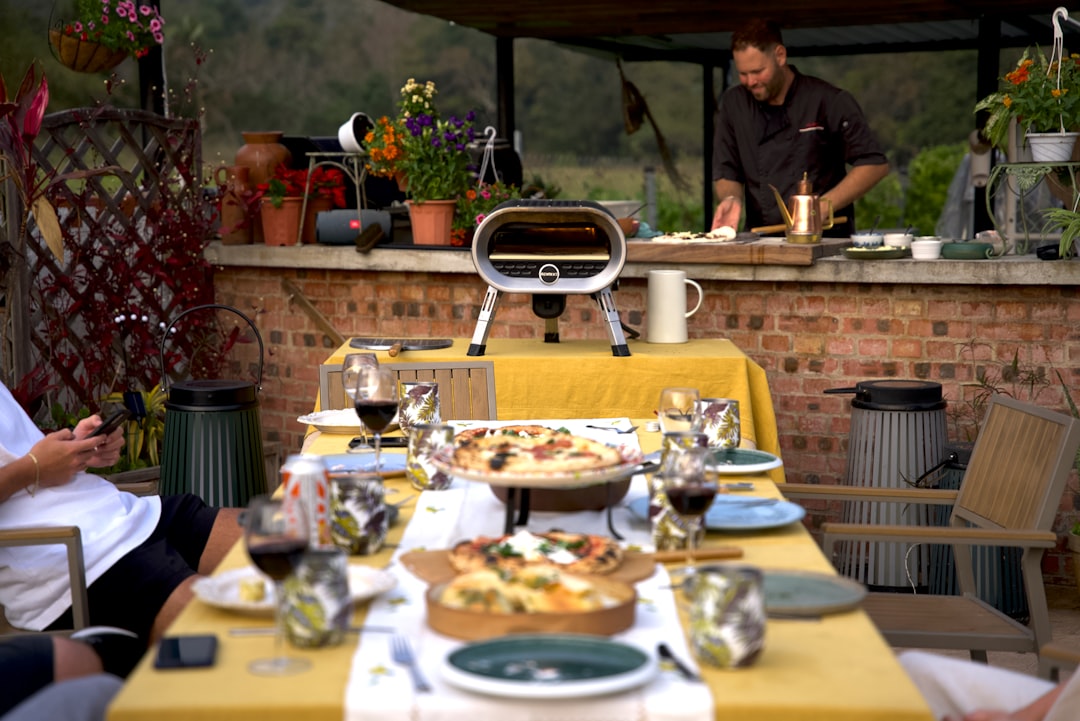 A group of people sitting around a table with food on it family dining, Mediterranean food, healthy meals, outdoor restaurant