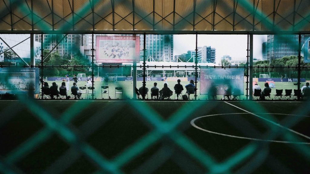 a group of people standing on top of a soccer field sports analytics, teamwork, cybersecurity measures