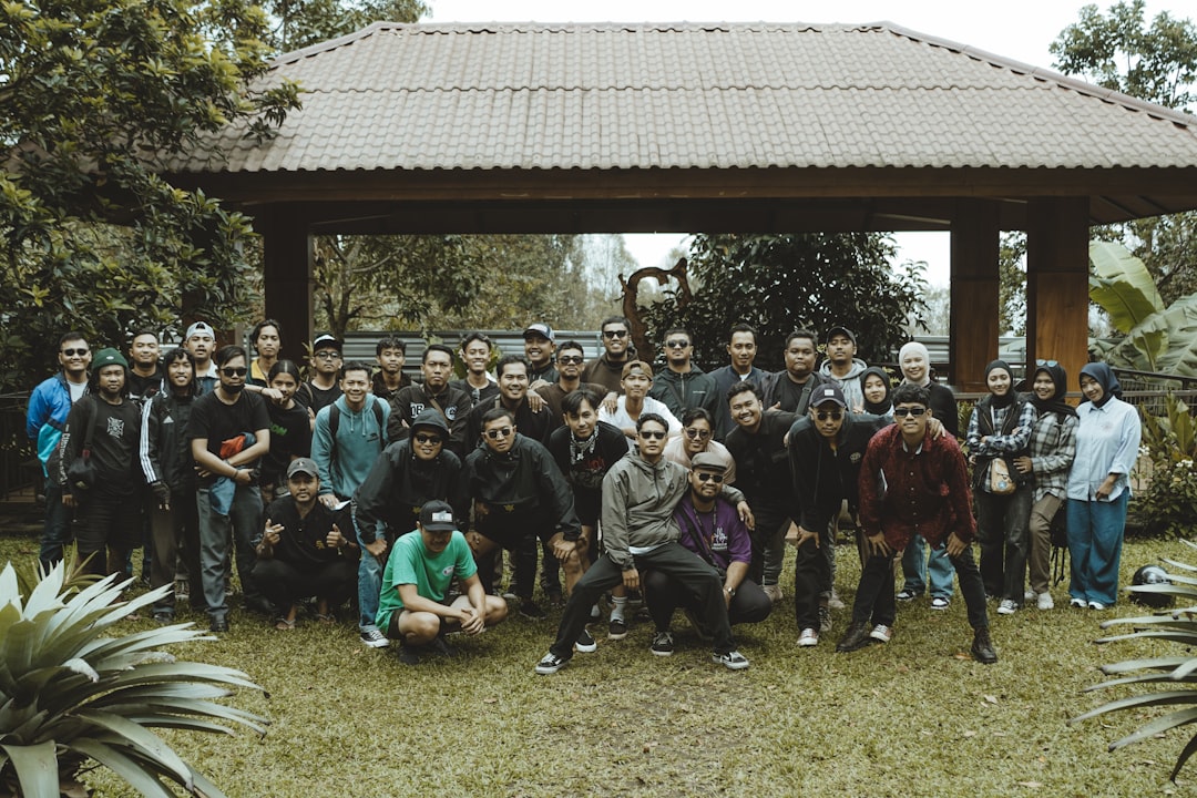A large group of people posing for a picture. team bonding, camping trip, football players outdoors