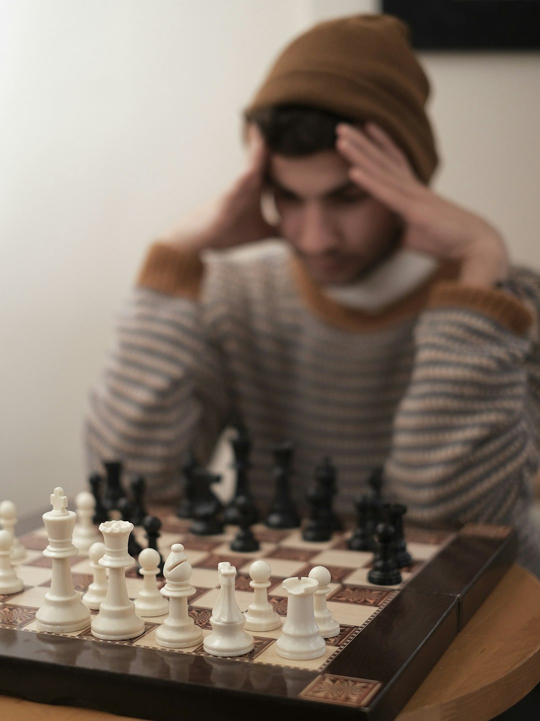 a man sitting at a table with a chess board chess board, mindset, emotional control