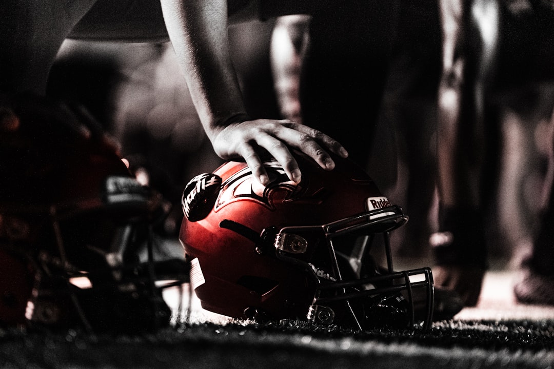 a person holding a helmet nfl players, football roster cuts, athlete tryouts