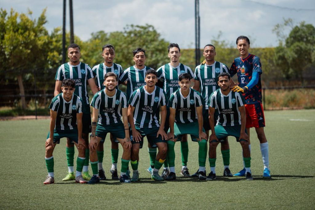 A soccer team stands together on a field. puebla team, soccer lineup, liga mx match