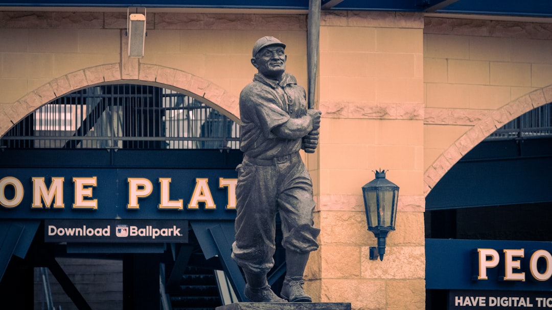 a statue of a baseball player in front of a building roberto clemente, pittsburgh pirates, latin baseball history