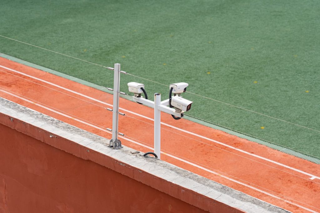 a white machine on a green field sports analytics, teamwork, cybersecurity measures