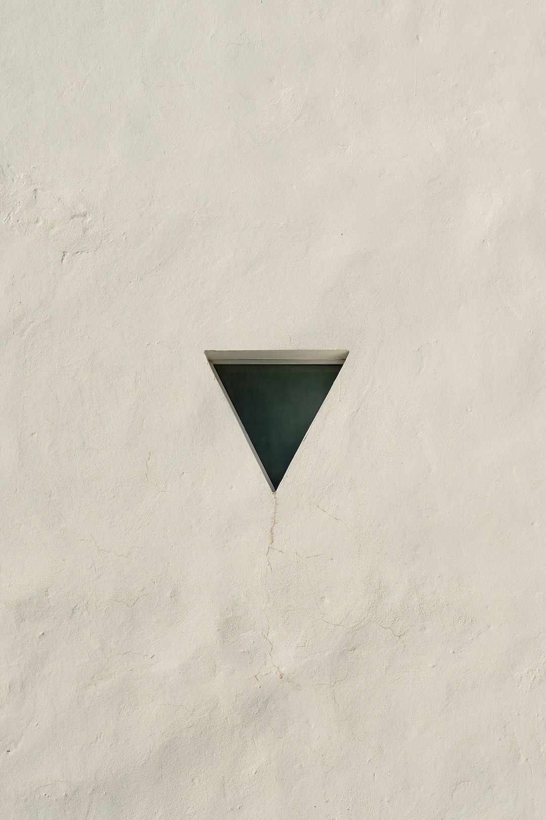 a white wall with a triangle shaped window geometric shapes, modern logo, tech photography branding