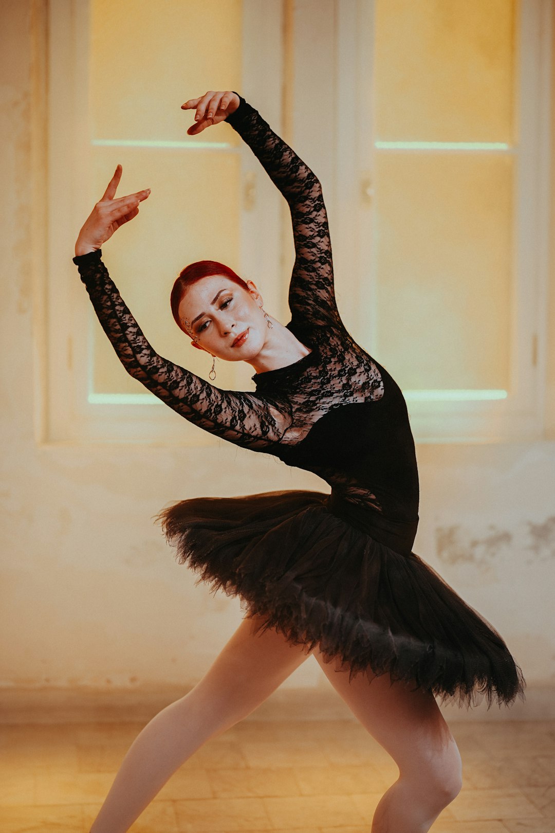 a woman in a black dress is dancing ballet dancer, emotional expression, artistic dance