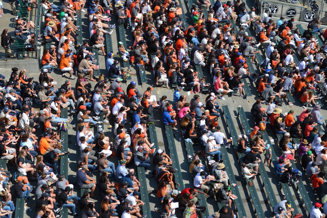 aerial photography of people sitting on benches during daytime nfl preseason football stadium crowd