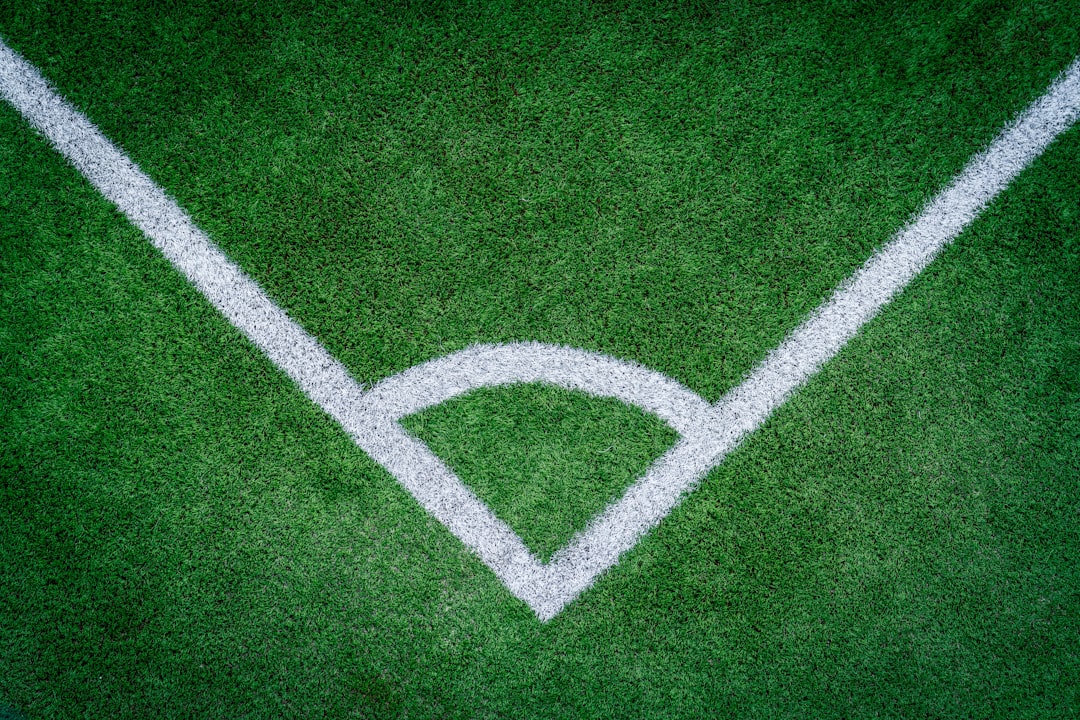 Corner of a green soccer field with white lines baseball batter leadoff stats field