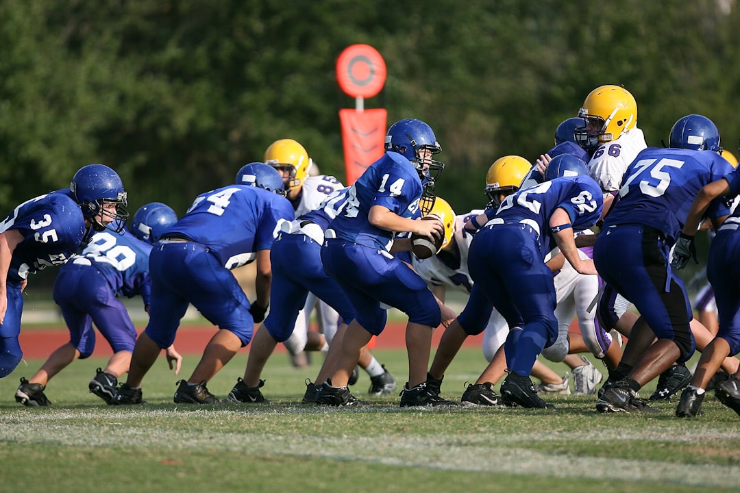 football players on football field teambuilding activities, high school football huddle, players bonding