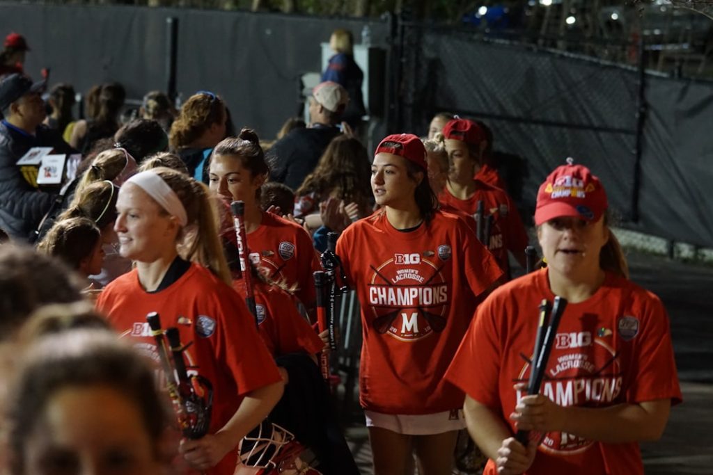 group of women holding sticks millikin fans, college football mascots, cheerleaders, tailgate