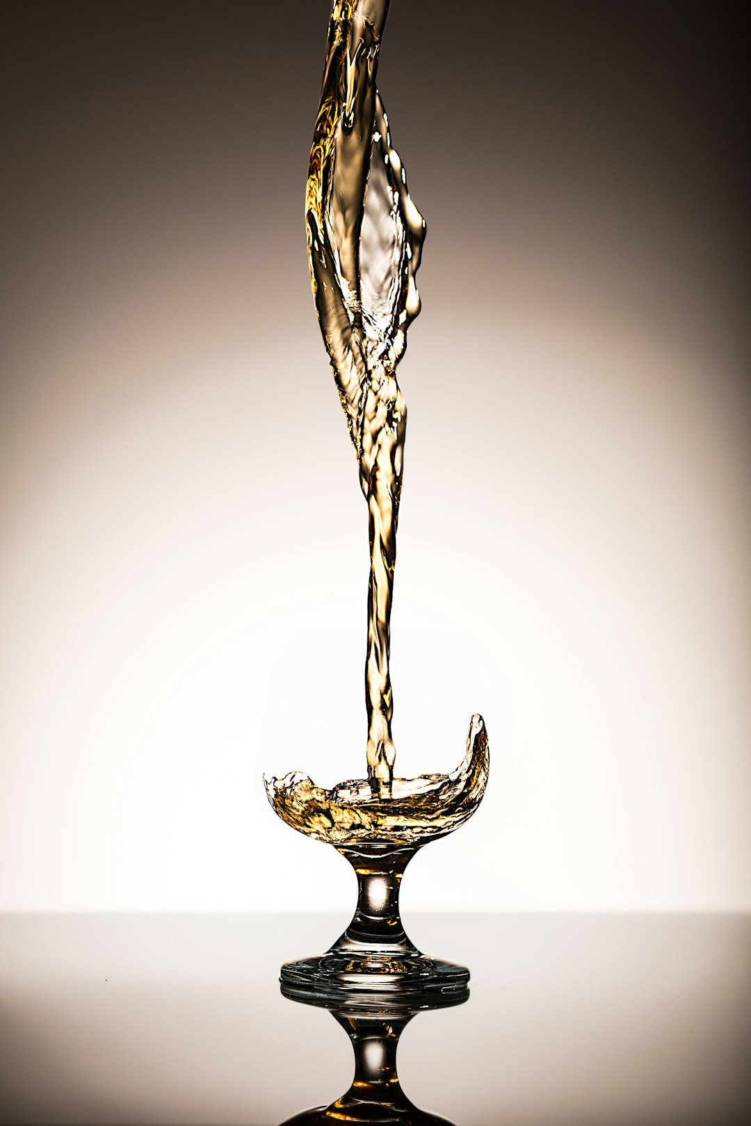 liquid pouring on clear short stem wine glass wildcatters championship trophy celebration