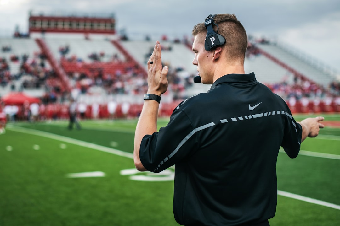 man in black crew neck t shirt wearing black sunglasses virtual reality football, coach training, quarterback view