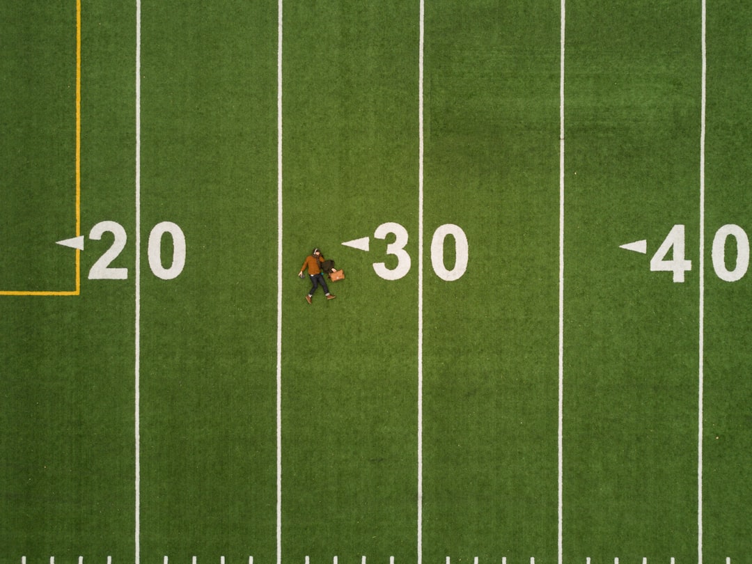 man lying on 30 yards on football field fantasy football stats lineup players