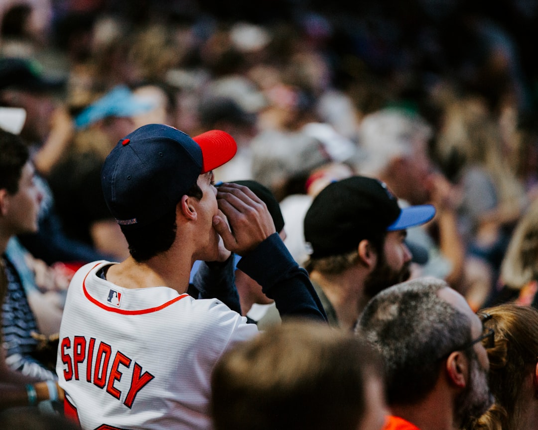 man shouting selective focus photography wildcatters baseball stadium fans