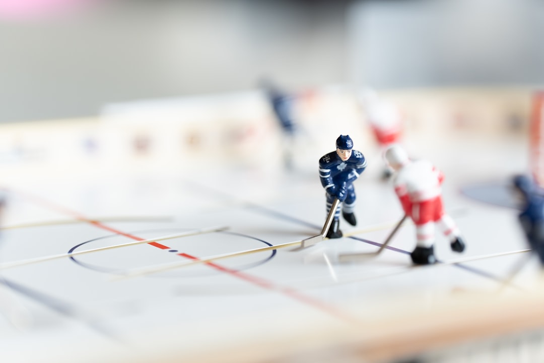 Miniature hockey game on a tabletop rink. sports analytics, rating system, betting data