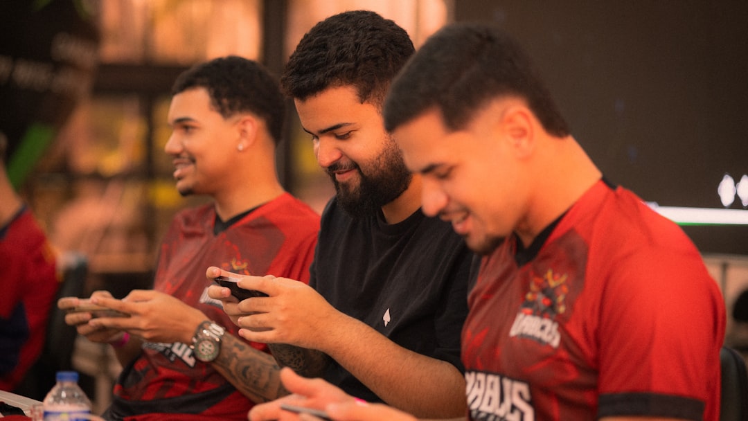 Three men playing mobile games together football community, fans chatting, online sports discussion