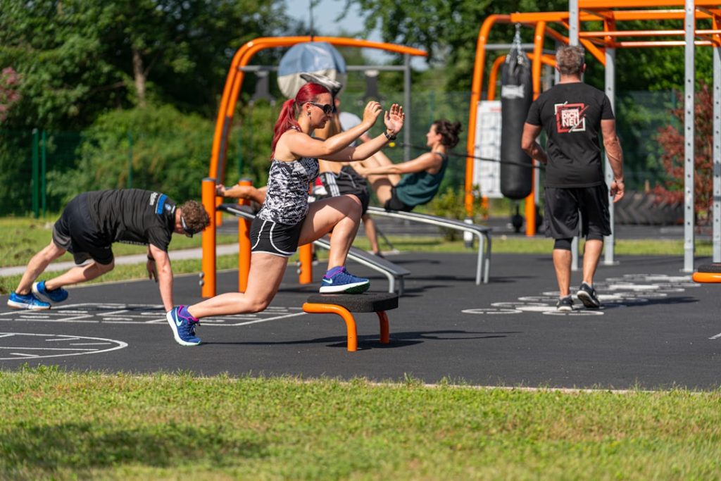unknown person exercising outdoors wicksburg football training, high school athletes lifting, early morning practice