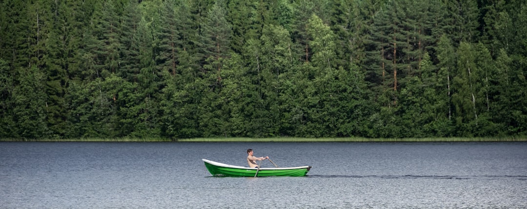 woman in blue shirt riding on green boat on river during daytime kayaker, paddle stroke, lake, summer