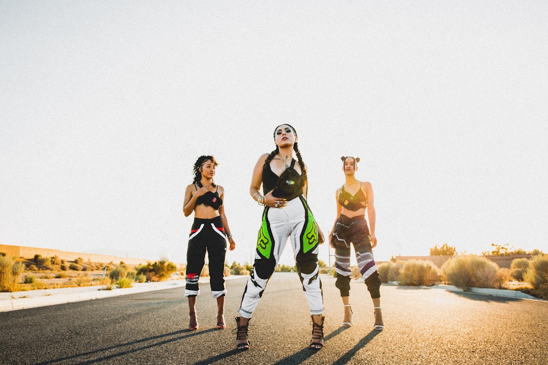 woman standing on asphalt road surrounded by bushes fitness community, wearable tech, group challenge