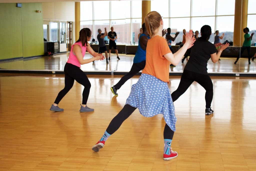 women dancing near mirror competitive ballroom dance, dance competition, athletic dancers