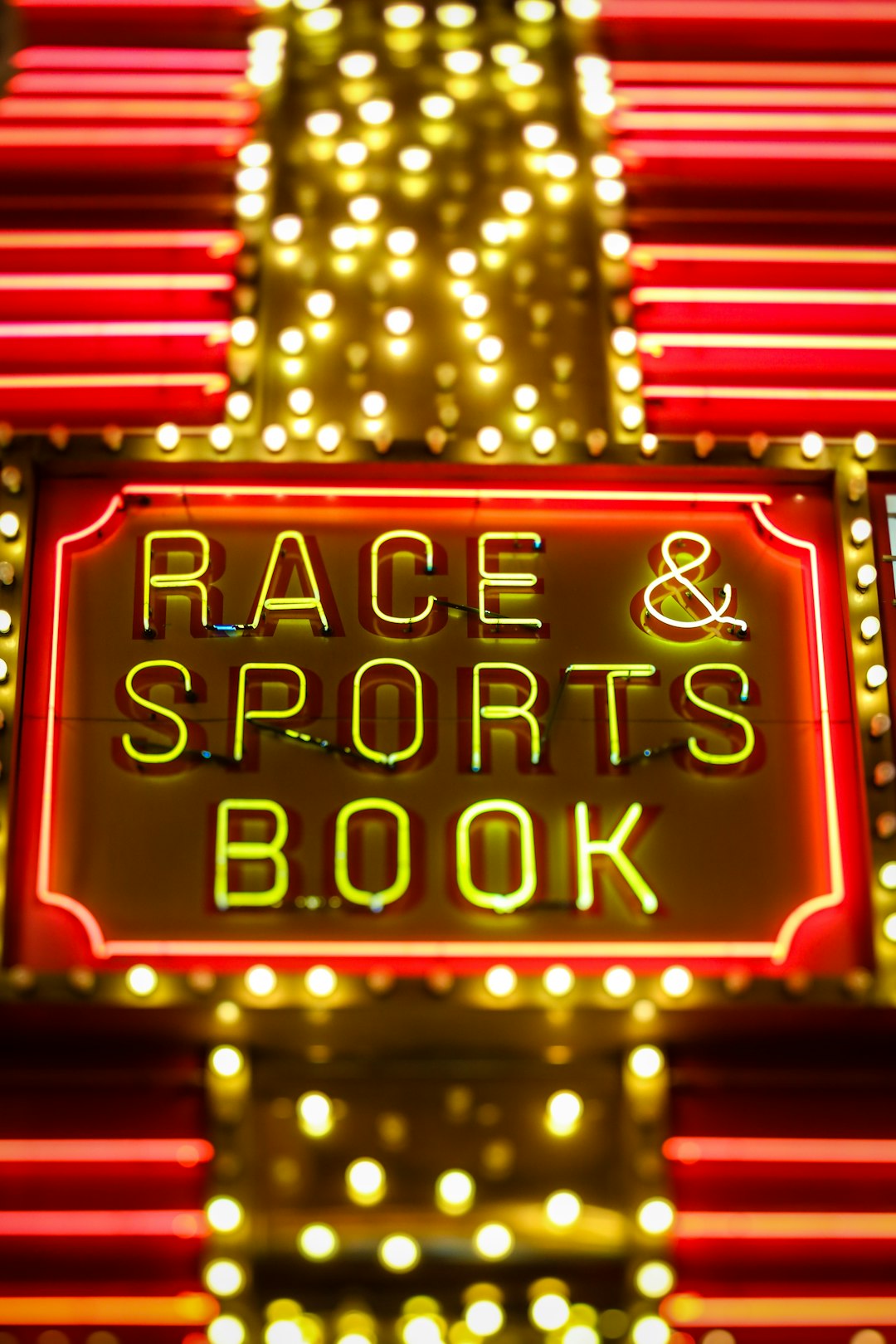 yellow and red race sports & book neon light live sports betting, fluctuating odds, sportsbook interface