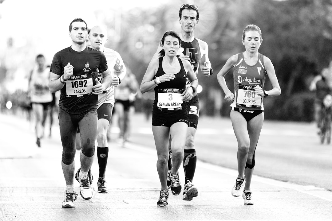 2 women running on road elite athletes, sports drinks, endurance running, competition