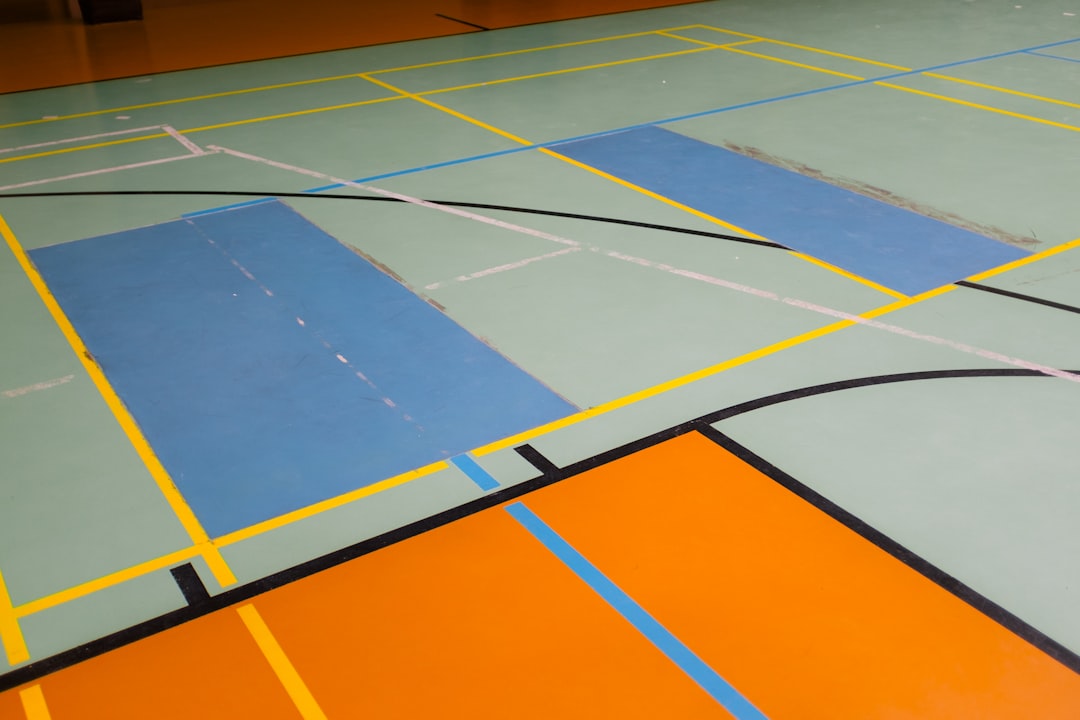 a basketball court with lines painted on it indoor gym flooring hardwood rubber court