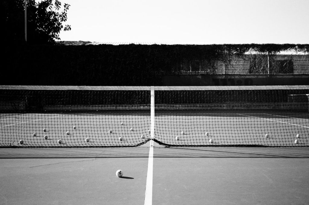 a black and white photo of a tennis court nfl players, football roster cuts, athlete tryouts