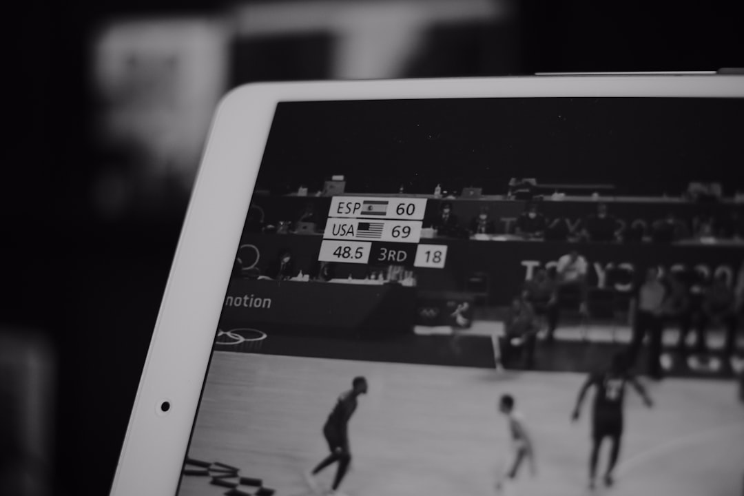 a close up of a person holding a tablet fantasy football app, mobile dashboard, team management