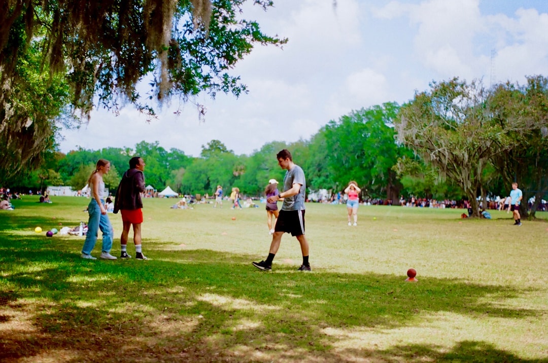 a group of people standing on top of a lush green field jalen milroe, alabama quarterback, touchdown celebration