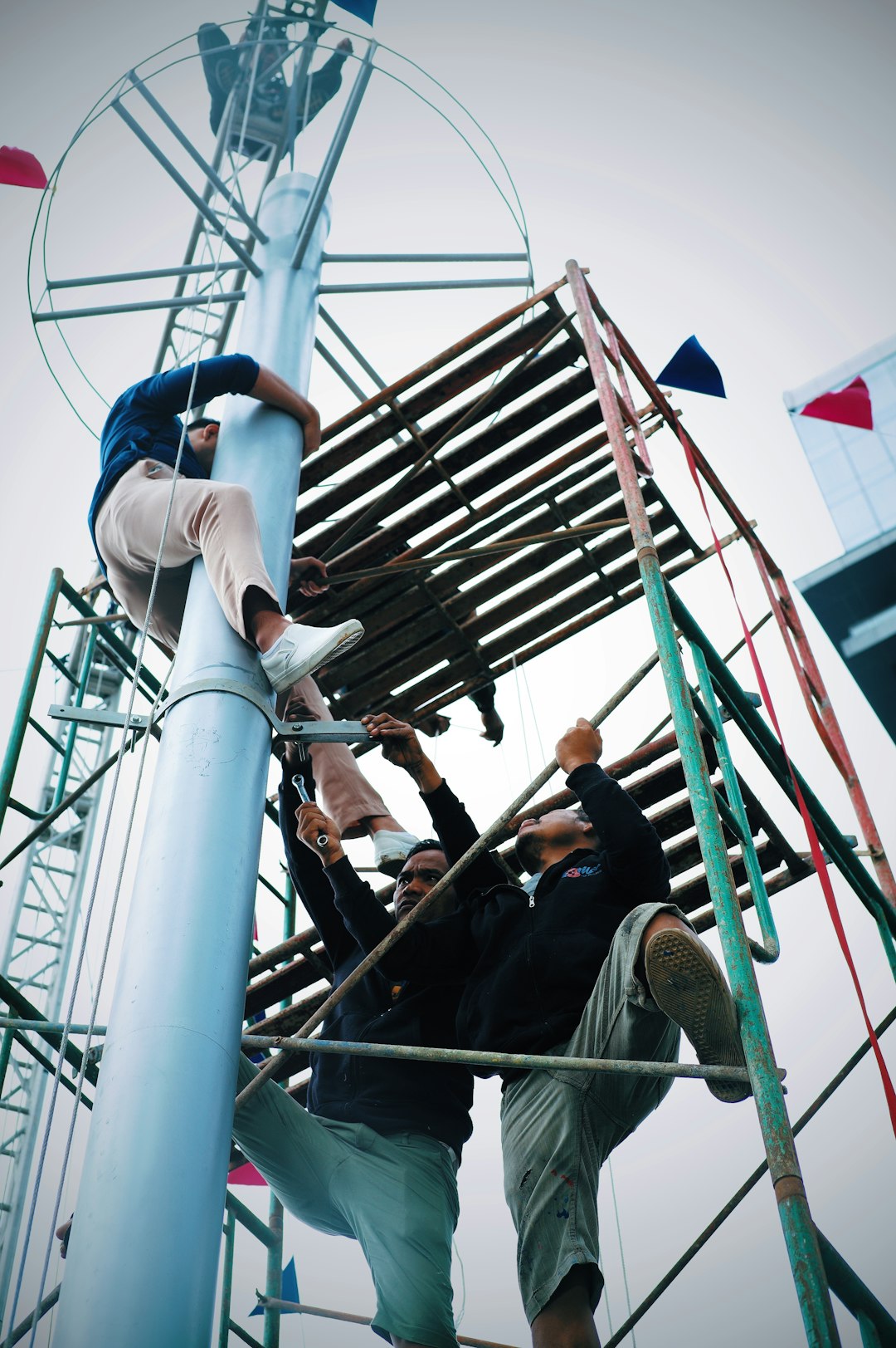 a group of people standing on top of a metal structure training equipment, resistance bands, agility ladder