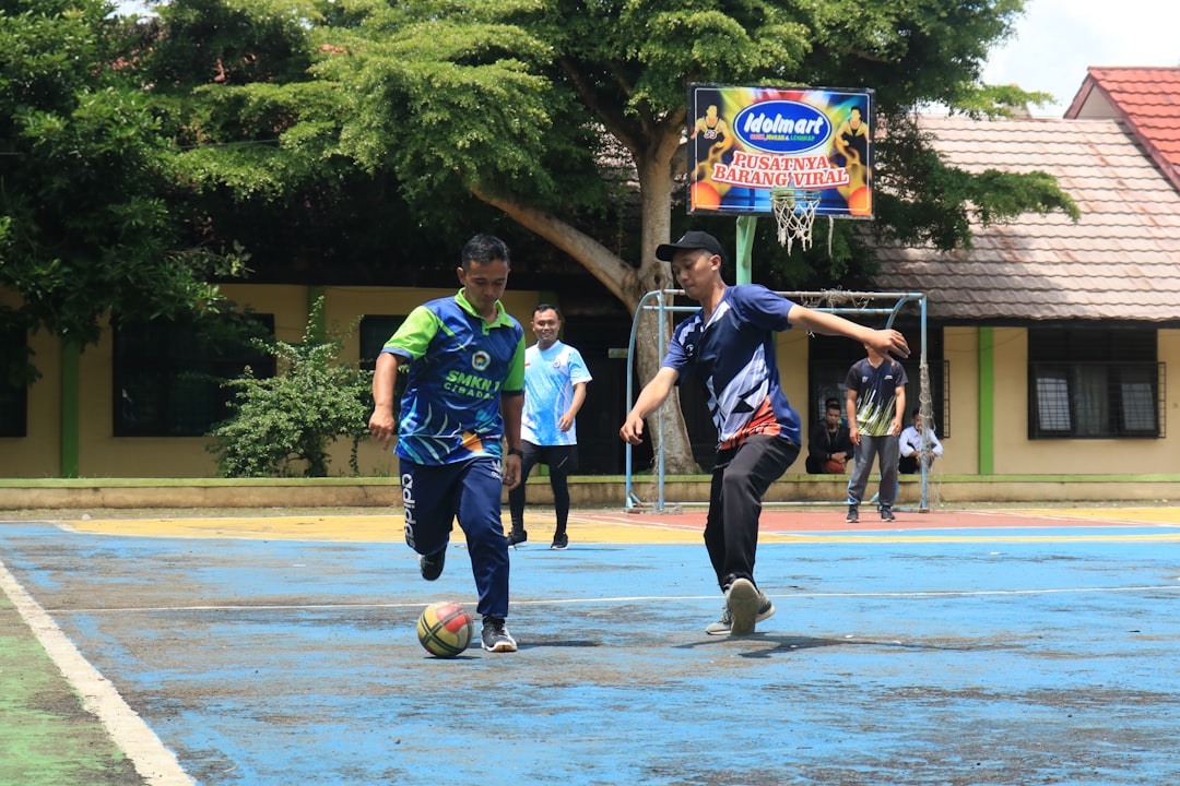 A group of young men playing a game of soccer football rivalry, head to head matchup, teams facing