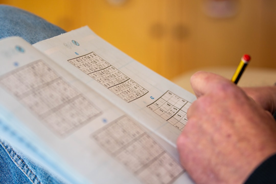 a person is holding a piece of paper with numbers on it betting notebook, tracking results, sports betting record
