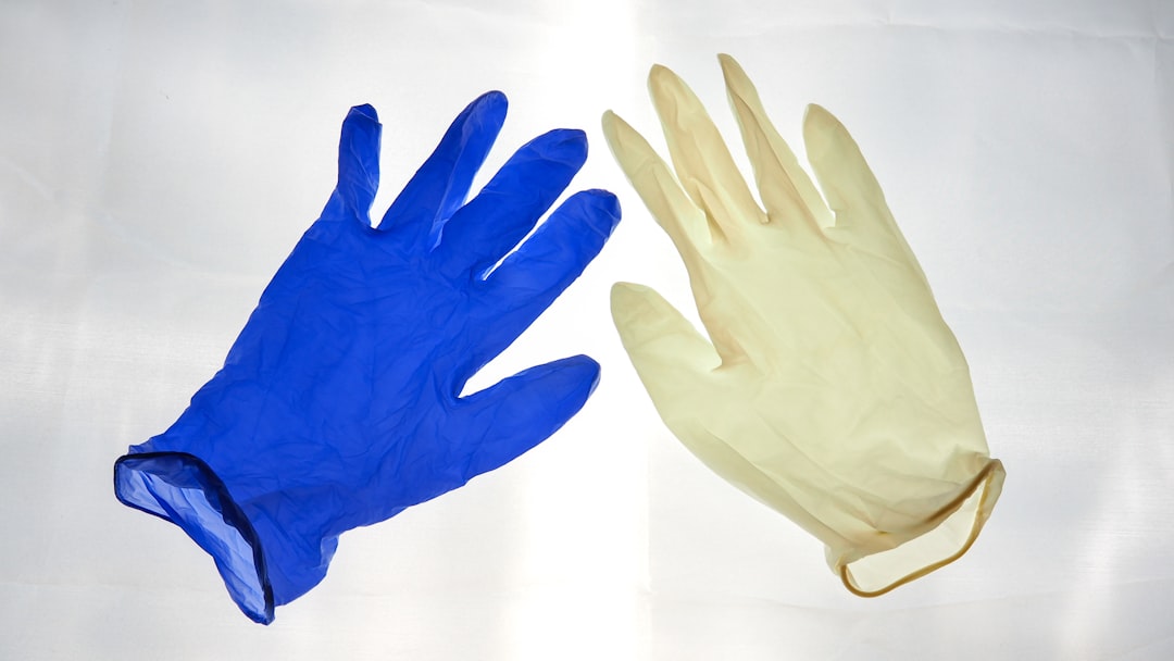 blue gloves on white surface football glove fit, hand sizing, youth football gloves