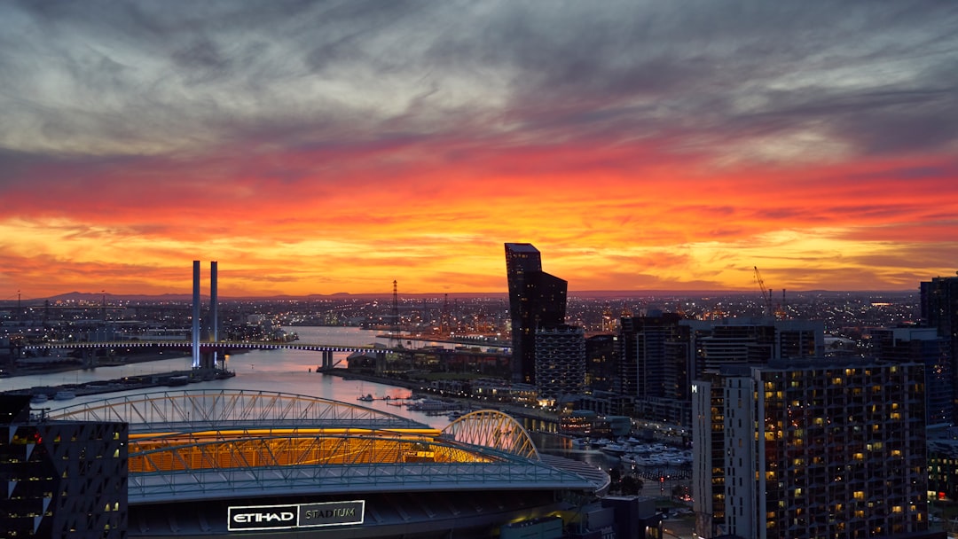 city skyline during orange sunset melbourne united, sydney kings, basketball rivalry