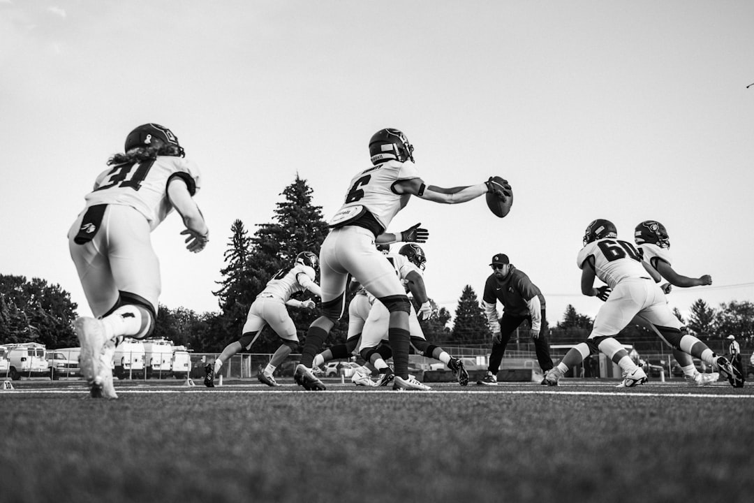 Football players in action on field during game modern football linebacker celebration nfl college
