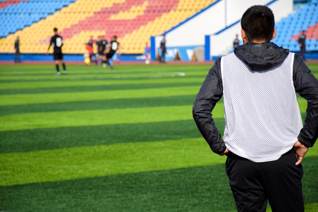 person looking at soccer field coach player training strategy
